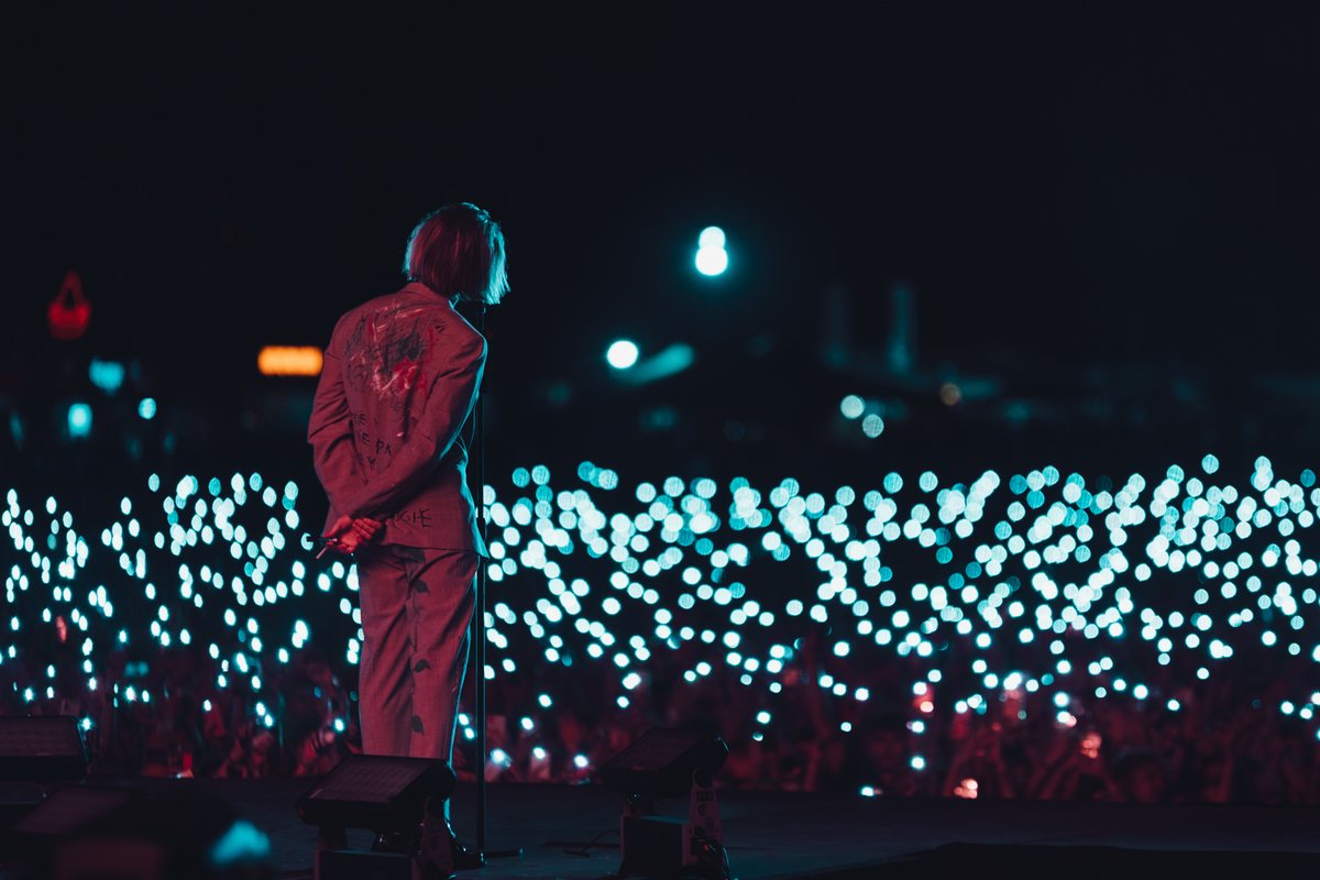 Artysta na scenie przed morzem świateł z telefonów